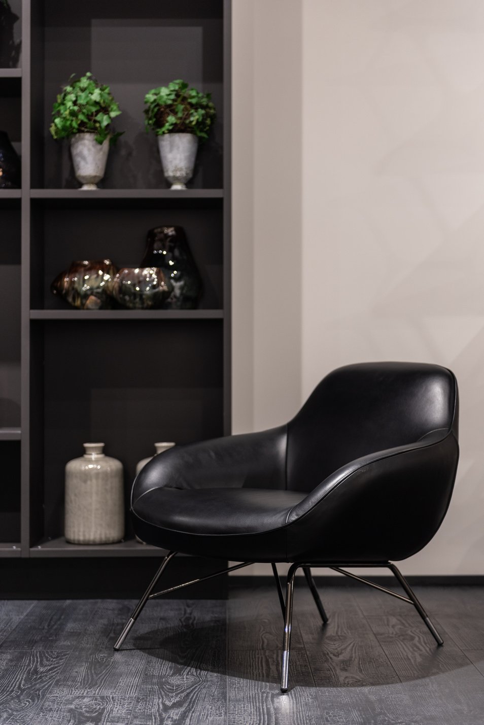 Black armchair near decorated shelves